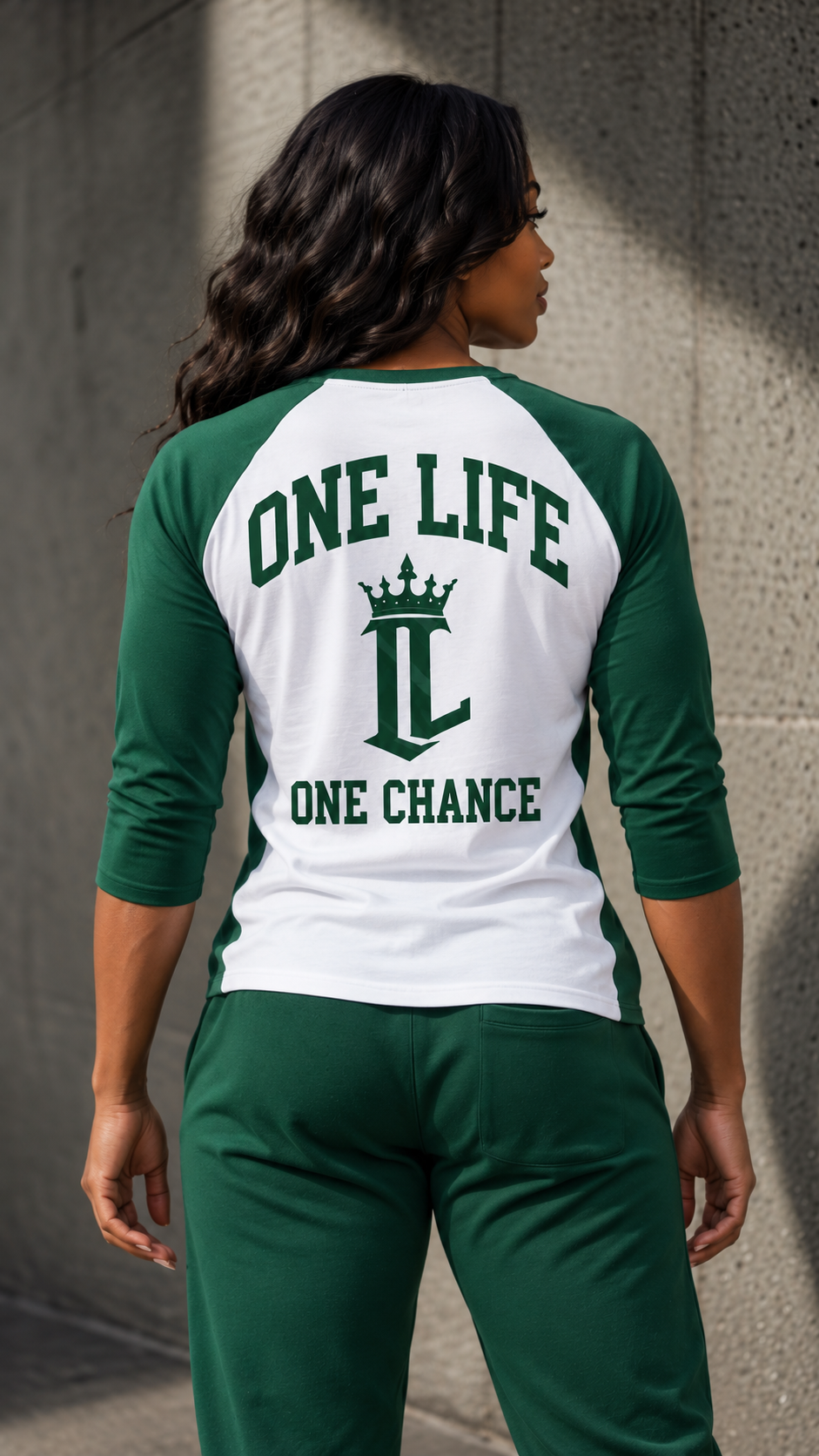 Women's model wearing the Ascension Baseball Tee by One Life Clothing — corrected back view.