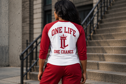 Women's model wearing Defining Moment Baseball Tee — back view with corrected original back design