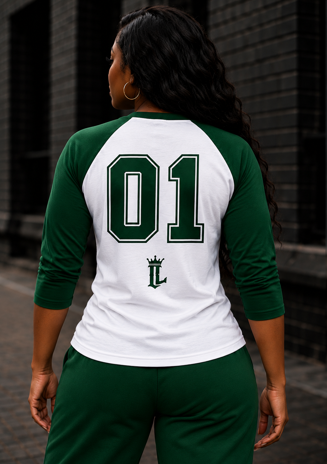 Women's model wearing the Evergreen Baseball Tee by One Life Clothing — corrected back view.