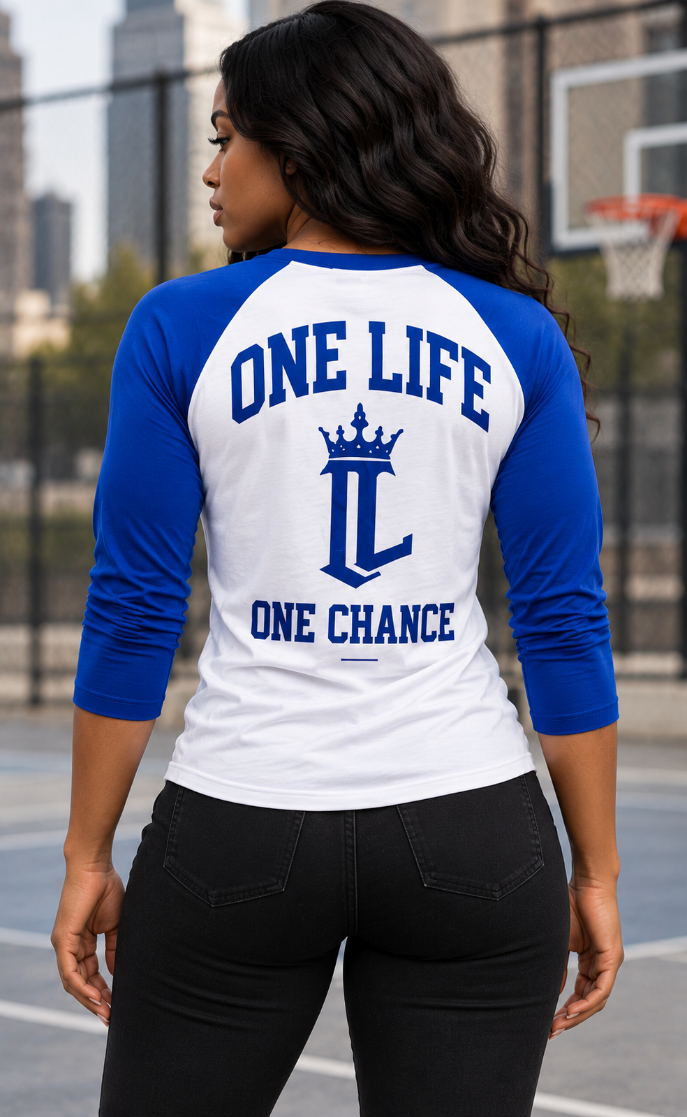 Women's model wearing the Resolve Baseball Tee by One Life Clothing — corrected back view.
