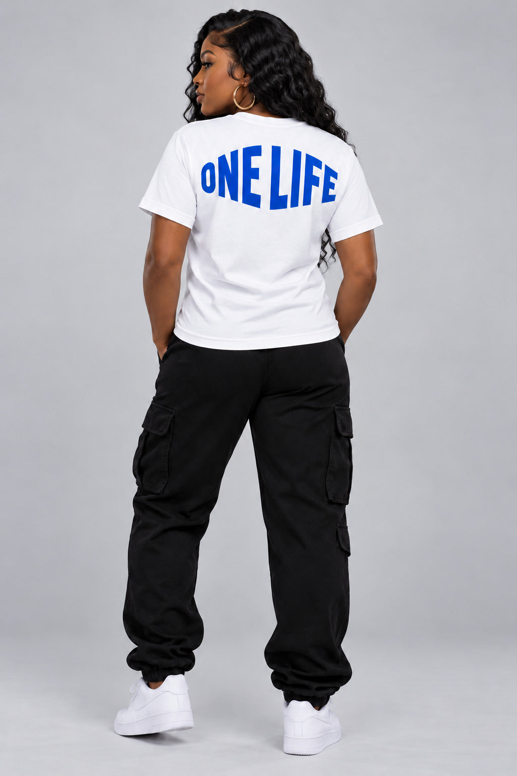 Women’s model wearing the Blue Blood Tee — back view. No back rhinestones.