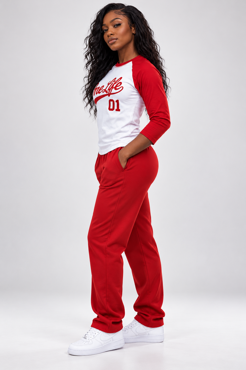 Women's model wearing the First Inning Baseball Tee by One Life Clothing — side view.