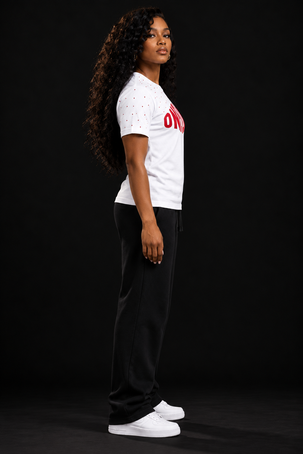 Women's model wearing the Ignition Tee by One Life Clothing — side view.