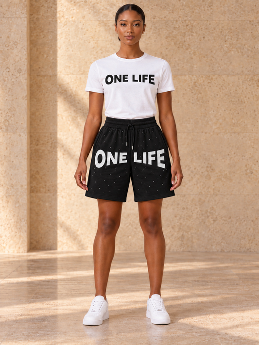 Women's No Sleep black shorts with a white One Life shirt featuring a black logo, front view.