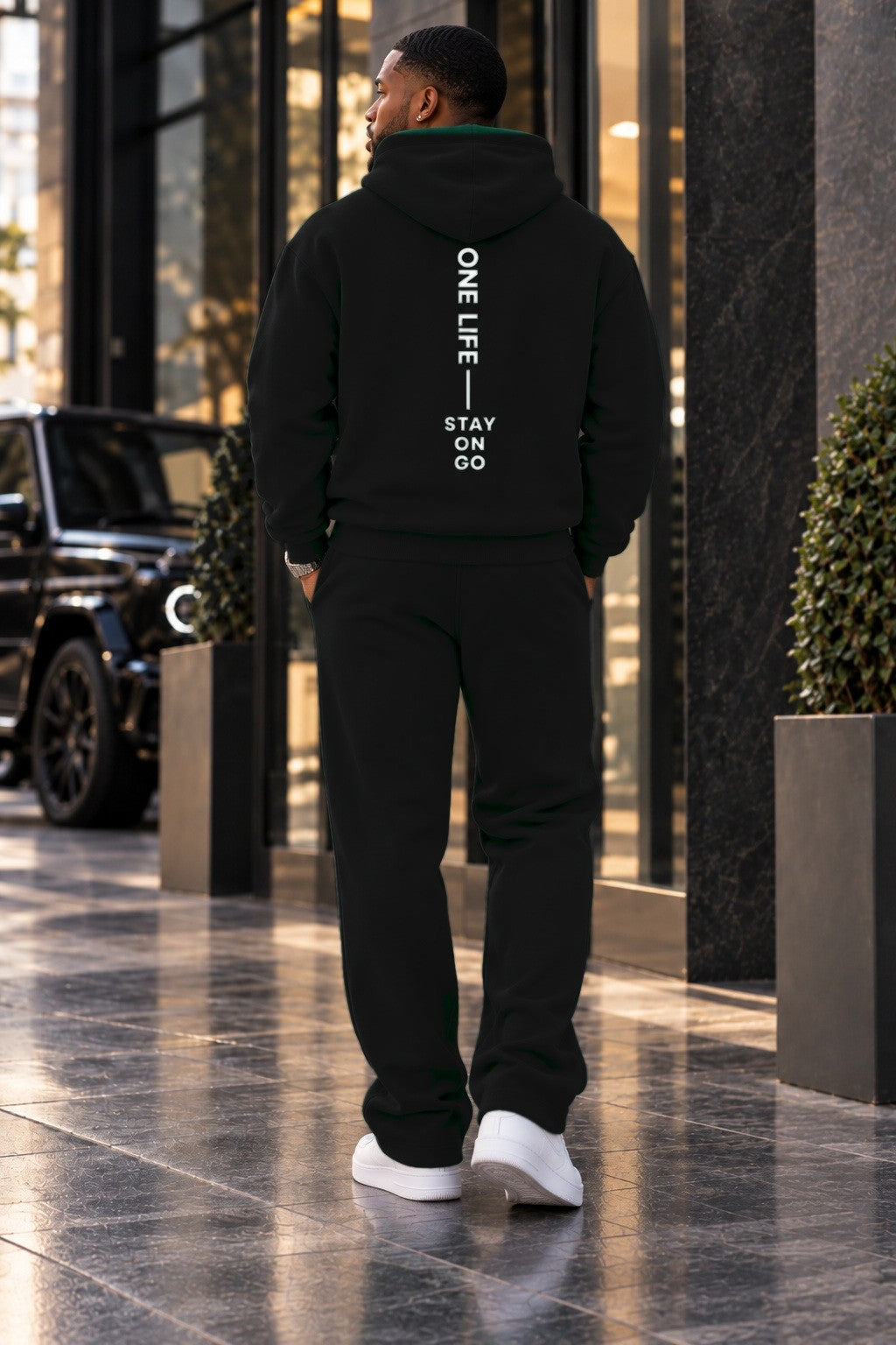 Male model wearing the Black ON GO Set, back with STAY ON GO artwork